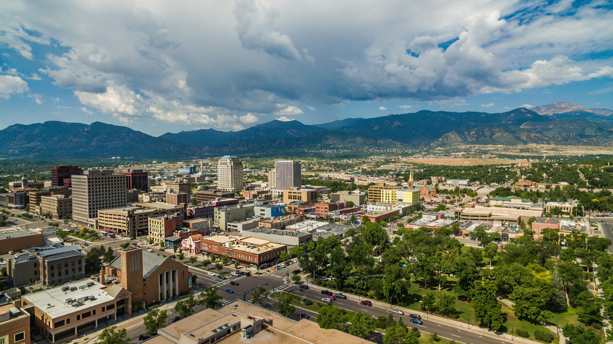 Downtown Colorado Springs with the Rocky Mountains and Pikes Peak behind it